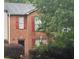 Two-story brick home with red shutters and a well-maintained front yard at 338 Saratoga Pl, Riverdale, GA 30296