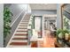 Inviting foyer with hardwood floors, staircase, and stylish decor at 338 Saratoga Pl, Riverdale, GA 30296