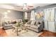 Comfortable living room featuring two sofas and decorative mirrors at 338 Saratoga Pl, Riverdale, GA 30296