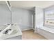 Bathroom featuring dual sinks, separate shower and soaking tub, and lots of natural light at 750 Ambrose Ln, Atlanta, GA 30349