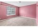 Bedroom with pink walls featuring window with lots of natural light at 750 Ambrose Ln, Atlanta, GA 30349
