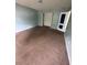 Spacious bedroom featuring carpet flooring and a large walk-in closet at 750 Ambrose Ln, Atlanta, GA 30349