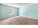 Bedroom with plush carpet, light-filled room featuring a large window at 750 Ambrose Ln, Atlanta, GA 30349