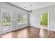 Well-lit dining area with hardwood floors and access to the backyard, ideal for indoor-outdoor living at 750 Ambrose Ln, Atlanta, GA 30349