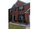 Two-story brick home with black shutters and well-manicured landscaping at 750 Ambrose Ln, Atlanta, GA 30349