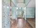 Inviting foyer with hardwood flooring, an elegant glass front door, and a view of the staircase at 750 Ambrose Ln, Atlanta, GA 30349