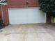 A garage featuring a white garage door and a concrete driveway at 750 Ambrose Ln, Atlanta, GA 30349