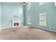 Spacious living room featuring a fireplace, large windows, and a ceiling fan at 750 Ambrose Ln, Atlanta, GA 30349