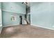 Bright living room with a view of the kitchen and staircase, offering an open concept layout at 750 Ambrose Ln, Atlanta, GA 30349
