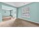 Comfortable living area with a large window and access to an adjacent room with hardwood floors at 750 Ambrose Ln, Atlanta, GA 30349