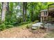 Picturesque backyard with mature trees, featuring a deck and stairs that enhances the outdoor living experience at 1102 Rogeretta Ne Dr, Atlanta, GA 30329