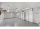 View of a clean basement space with concrete floors and white storage shelving at 1102 Rogeretta Ne Dr, Atlanta, GA 30329