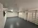 Large basement featuring painted walls and floor, open shelving and ceiling fan at 1102 Rogeretta Ne Dr, Atlanta, GA 30329
