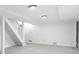 Finished basement features white walls, neutral carpet, staircase, and a door to the outside at 1102 Rogeretta Ne Dr, Atlanta, GA 30329