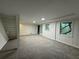 Spacious basement featuring stairwell to the upper levels and a window overlooking a wooded area at 1102 Rogeretta Ne Dr, Atlanta, GA 30329