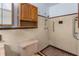 Bathroom featuring vintage tiled walls, wooden vanity, and accessible shower area at 1102 Rogeretta Ne Dr, Atlanta, GA 30329