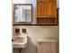 Vintage bathroom with tiled walls, wooden vanity, and a classic sink and toilet at 1102 Rogeretta Ne Dr, Atlanta, GA 30329