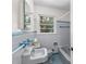 Bathroom featuring blue tile, a window for light, and a vintage sink and bathtub at 1102 Rogeretta Ne Dr, Atlanta, GA 30329