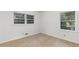 A cozy bedroom with neutral carpeting and natural light from two windows offers a peaceful retreat at 1102 Rogeretta Ne Dr, Atlanta, GA 30329