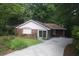 Charming brick home with bay window, sliding glass door, and inviting driveway at 1102 Rogeretta Ne Dr, Atlanta, GA 30329