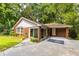 Charming brick home featuring a well-manicured lawn, mature trees, and a concrete driveway at 1102 Rogeretta Ne Dr, Atlanta, GA 30329