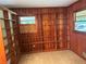 Cozy home office featuring wooden walls, custom built-in shelving, and natural light at 1102 Rogeretta Ne Dr, Atlanta, GA 30329