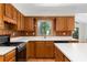 Kitchen corner with light oak cabinets, black gas range and sink view of outdoors at 1102 Rogeretta Ne Dr, Atlanta, GA 30329