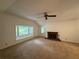 Bright living room featuring a cozy fireplace and large windows showcasing the outdoor scenery at 1102 Rogeretta Ne Dr, Atlanta, GA 30329