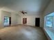 Spacious living room with neutral carpet, large windows, and multiple entryways at 1102 Rogeretta Ne Dr, Atlanta, GA 30329