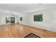 Spacious living room with hardwood floors, large windows, and sliding glass doors to a balcony at 1102 Rogeretta Ne Dr, Atlanta, GA 30329