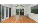 A bright room with hardwood floors, a vaulted ceiling, and sliding doors leading to a balcony at 1102 Rogeretta Ne Dr, Atlanta, GA 30329