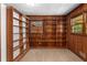 Bright office with wood paneled walls, carpet flooring and a window framed by bookshelves at 1102 Rogeretta Ne Dr, Atlanta, GA 30329
