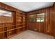 Bright office with wood paneled walls, carpet flooring and built in bookshelves at 1102 Rogeretta Ne Dr, Atlanta, GA 30329