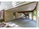 Covered patio with a white door, brick wall, and wooden steps, offering a functional outdoor space at 1102 Rogeretta Ne Dr, Atlanta, GA 30329
