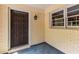 Covered porch with brick walls, an exterior light, and a solid wood door, providing a welcoming entry at 1102 Rogeretta Ne Dr, Atlanta, GA 30329