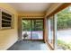 Bright sunroom with large windows and sliding glass doors, offering access to a patio and lush greenery at 1102 Rogeretta Ne Dr, Atlanta, GA 30329