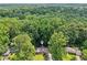 Aerial view showcases the home nestled among mature trees in a wooded setting at 2233 Clairmont Ne Rd, Atlanta, GA 30329