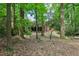View of the backyard of the home with mature trees and a brick exterior at 2233 Clairmont Ne Rd, Atlanta, GA 30329