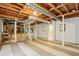 Unfinished basement with exposed beams, white-painted walls, and a staircase leading to the upper level at 2233 Clairmont Ne Rd, Atlanta, GA 30329