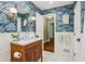 Beautiful bathroom with patterned wallpaper, a marble countertop and modern fixtures at 2233 Clairmont Ne Rd, Atlanta, GA 30329