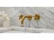 Close-up of a luxury bathroom with stylish marble countertops and unique brass fixtures for a touch of elegance at 2233 Clairmont Ne Rd, Atlanta, GA 30329