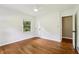 Cozy bedroom with hardwood floors, a ceiling fan, and an open closet at 2233 Clairmont Ne Rd, Atlanta, GA 30329