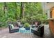 Outdoor deck with comfortable seating arrangements, potted plants, and a view of the lush greenery at 2233 Clairmont Ne Rd, Atlanta, GA 30329