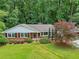 Charming brick home featuring a well-manicured lawn and mature landscaping at 2233 Clairmont Ne Rd, Atlanta, GA 30329