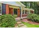 Inviting front porch with brick facade, iron railings, and landscaped pathway at 2233 Clairmont Ne Rd, Atlanta, GA 30329