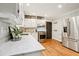Well-lit kitchen featuring white cabinets, stainless steel appliances, and marble countertops at 2233 Clairmont Ne Rd, Atlanta, GA 30329