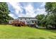Beautiful home exterior featuring a spacious backyard, wooden deck, a fun playset, and a charming, timeless appeal at 4047 Dunwoody Club Dr, Dunwoody, GA 30350