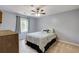 A serene bedroom with neutral walls, carpeted floors, a ceiling fan, and a window at 4047 Dunwoody Club Dr, Dunwoody, GA 30350