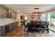 Dining room with a large table, gray cabinets, a wine cooler, and access to the living room at 4047 Dunwoody Club Dr, Dunwoody, GA 30350
