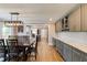 Dining room features modern light fixture, stylish gray cabinets, and hardwood floors at 4047 Dunwoody Club Dr, Dunwoody, GA 30350